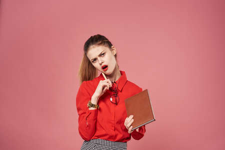 Business woman elegant style formal suit red shirt pink backgroundの写真素材