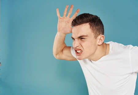 Energetic man clenched his hands into a fist and wide open mouth emotions modelの写真素材