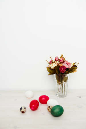 Easter church holiday colorful eggs and a bouquet of flowersの写真素材
