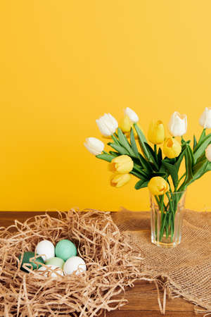 easter eggs in the nest bouquet of flowers decoration spring holiday