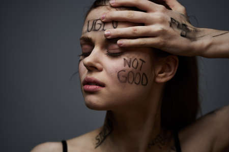 Emotional woman lettering on body communication gesture with hands black backgroundの写真素材