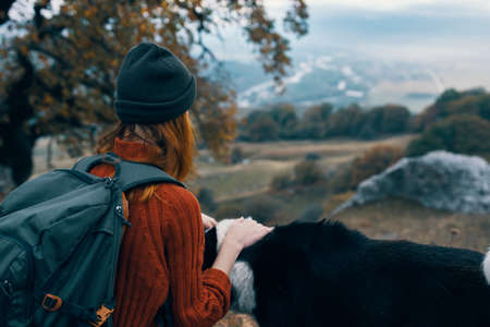 woman hiker next to dog nature mountains journey friendshipの写真素材