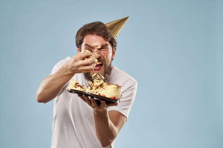 Cheerful man cake birthday celebration blue background