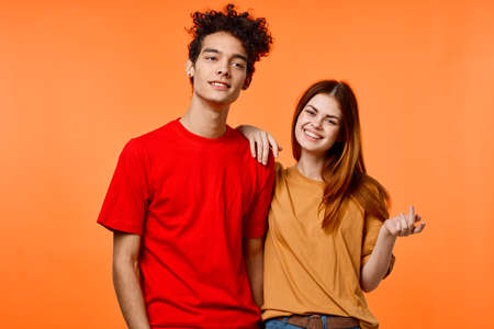 funny guy and girl in multicolored t-shirts modern style fashionの写真素材