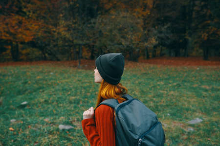 woman with backpack on her back hiking travel hat sweater model