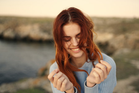 woman in blue sweater outdoors fresh air rocky mountains landscapeの写真素材