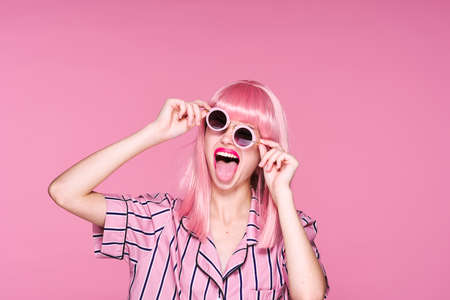 woman in trendy shirt and sunglasses wig on head cropped viewの写真素材