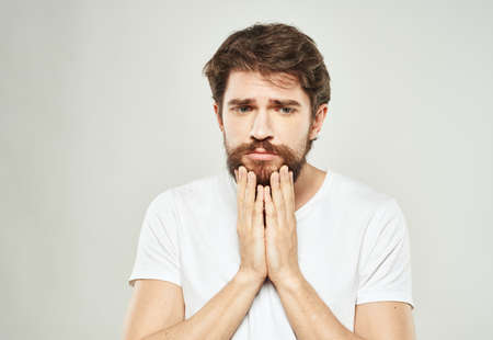 Man in t-shirt cropped view model sad face emotionsの写真素材