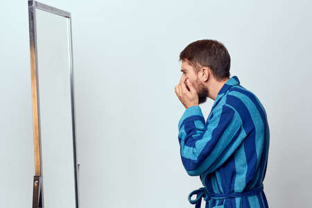 Man in a striped blue robe morning lifestyle emotionの写真素材