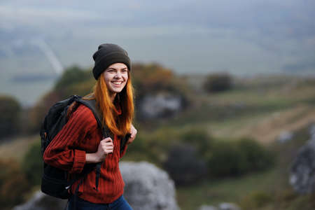 woman hiker with backpack in the mountains travel walking adventure