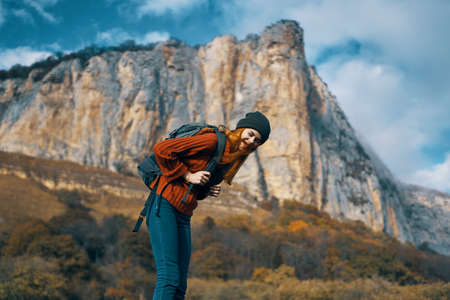 woman tourist with backpack on nature autumn season travel