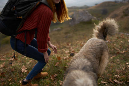 cheerful woman tourist next to dog nature friendship landscape travel