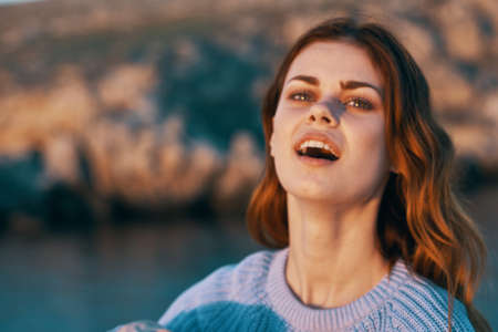 traveler in sweater on nature near lake river landscape tourism modelの写真素材