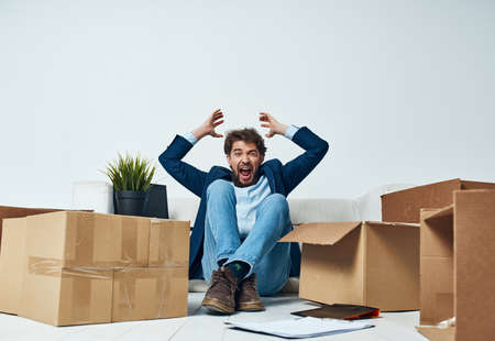 Business man emotions boxes with lifestyle things unpackingの写真素材