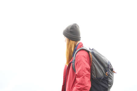 woman travels in the mountains with a backpack in the evening landscape clouds weatherの写真素材
