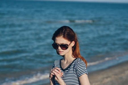 nature landscape woman near the sea on the beach in sunglassesの写真素材