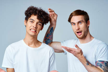 Two cheerful friends in white t-shirts emotions studioの写真素材