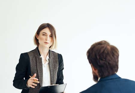 A man for an interview In a bright room talking to a woman oppositeの写真素材