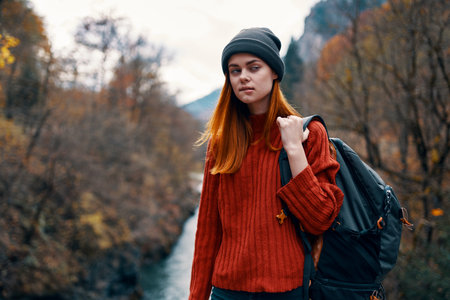 woman hiker on the bridge near the river mountains travel natureの写真素材