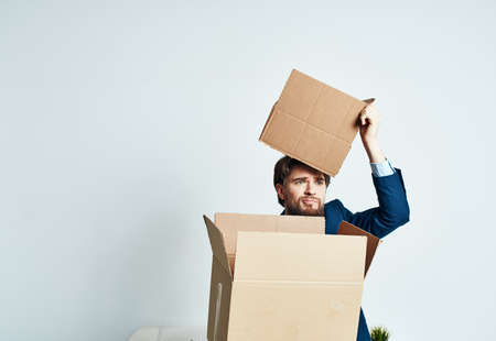 man with boxes in groups moving new place of work lifestyle officialの写真素材