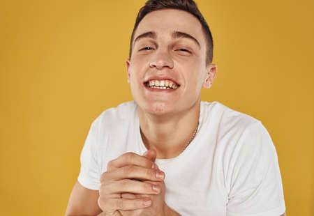 Man laughs on a yellow background Delight emotions joy modelの写真素材