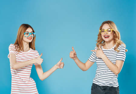 Two women in striped T-shirts emotions joy communication friendship