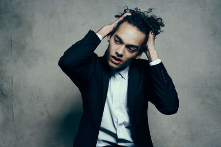 man with curly hair black jacket self confidence fashionの写真素材