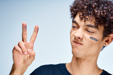 emotional man with curly hair cosmetics facial close-upの写真素材