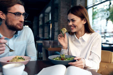 young couple in a cafe sitting at the table breakfast communication restの写真素材
