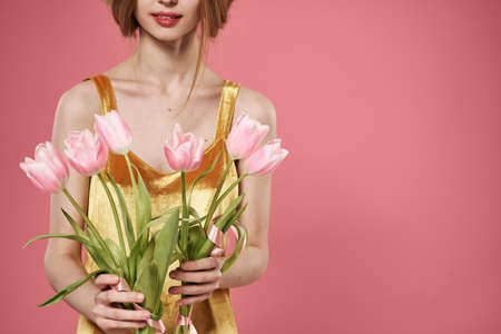 Woman with bouquet of flowers womens day 8 march pink backgroundの写真素材