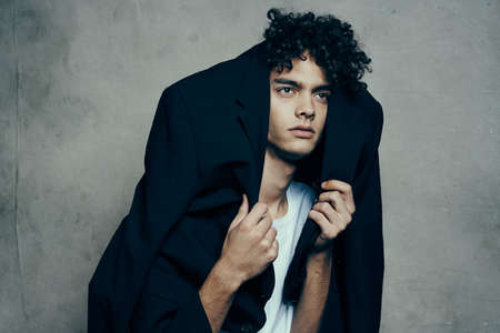 guy in suit curly hair t-shirt gray background model cropped view teenagerの写真素材