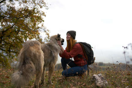 woman tourist playing dog nature landscape friendship