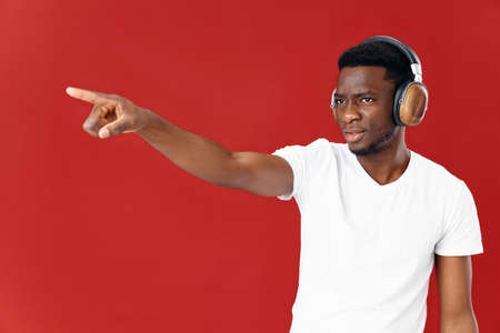 emotional man in headphones gesturing with hand circumcised with copy space