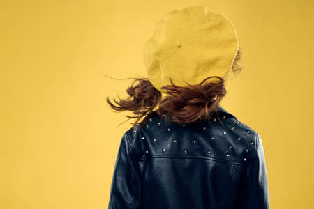 Girl in a yellow hat dark glasses fashionable clothes studio lifestyle childhood