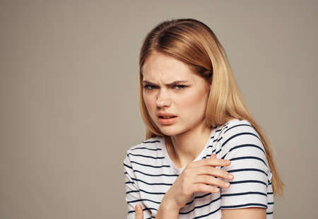 Upset woman model disgust emotions beige background portrait