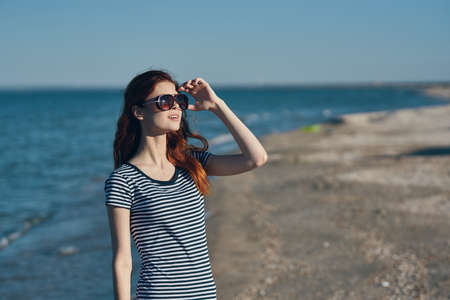 pretty traveler in a t-shirt resting on the beach in the mountains near the river in summer vacation Relaxの写真素材