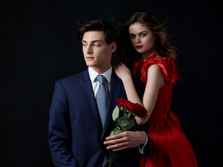 a young couple portrait luxury romance flowers dark backgroundの写真素材