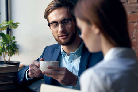 business man and woman sitting in cafe socializing breakfast lifestyleの写真素材