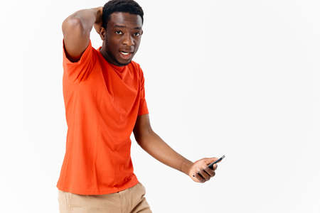 emotional African American with a phone in the hands of technology copy spaceの写真素材