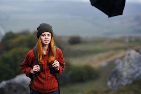 cheerful woman hiker with backpack in the mountains fresh air adventure lifestyle