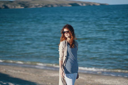 the traveler strolls along the beaches near the sea in the mountains waves landscape summerの写真素材