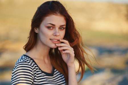 happy red-haired woman outdoors in the mountains smile model hairstyleの写真素材