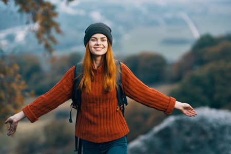 woman hiker with backpack in the mountains freedom landscape fresh air traveled