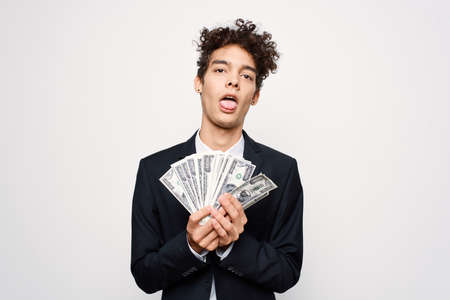 Cheerful man in a suit with money in the hands of a finance official