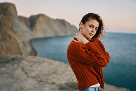 woman model travel tourism mountains oceans high cliffsの写真素材