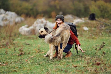 woman hiker backpack travel friendship walking the dog fun mountainsの写真素材