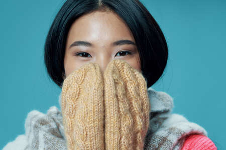 woman covered her face with gloves and a warm scarf model