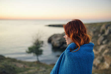 red-haired woman with blue plaid outdoors travel fresh airの写真素材