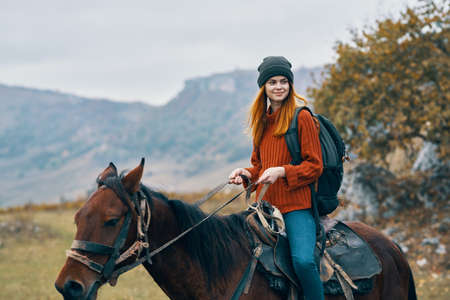 woman hiker ride horse mountains travel fresh airの写真素材