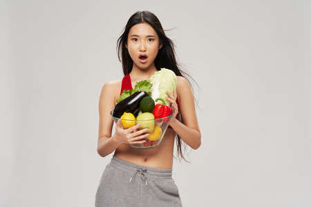 slender asian woman looking vegetables healthy food dietの写真素材